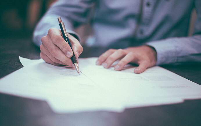 Image of business person filling out paperwork