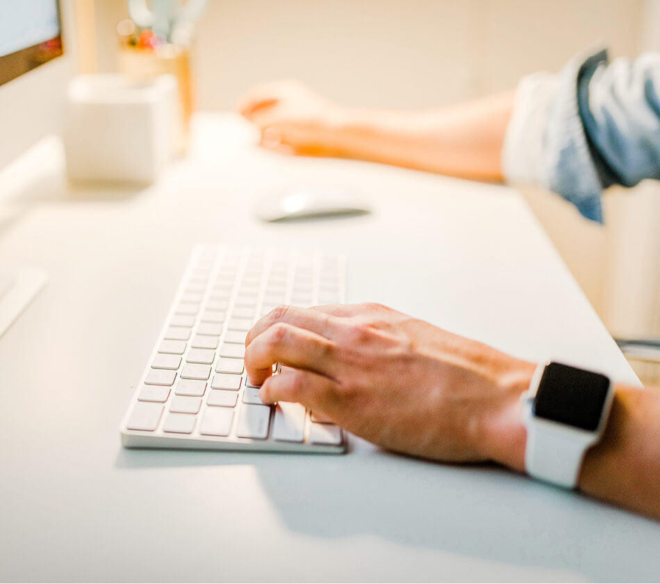 Image of a person typing on a keyboard.